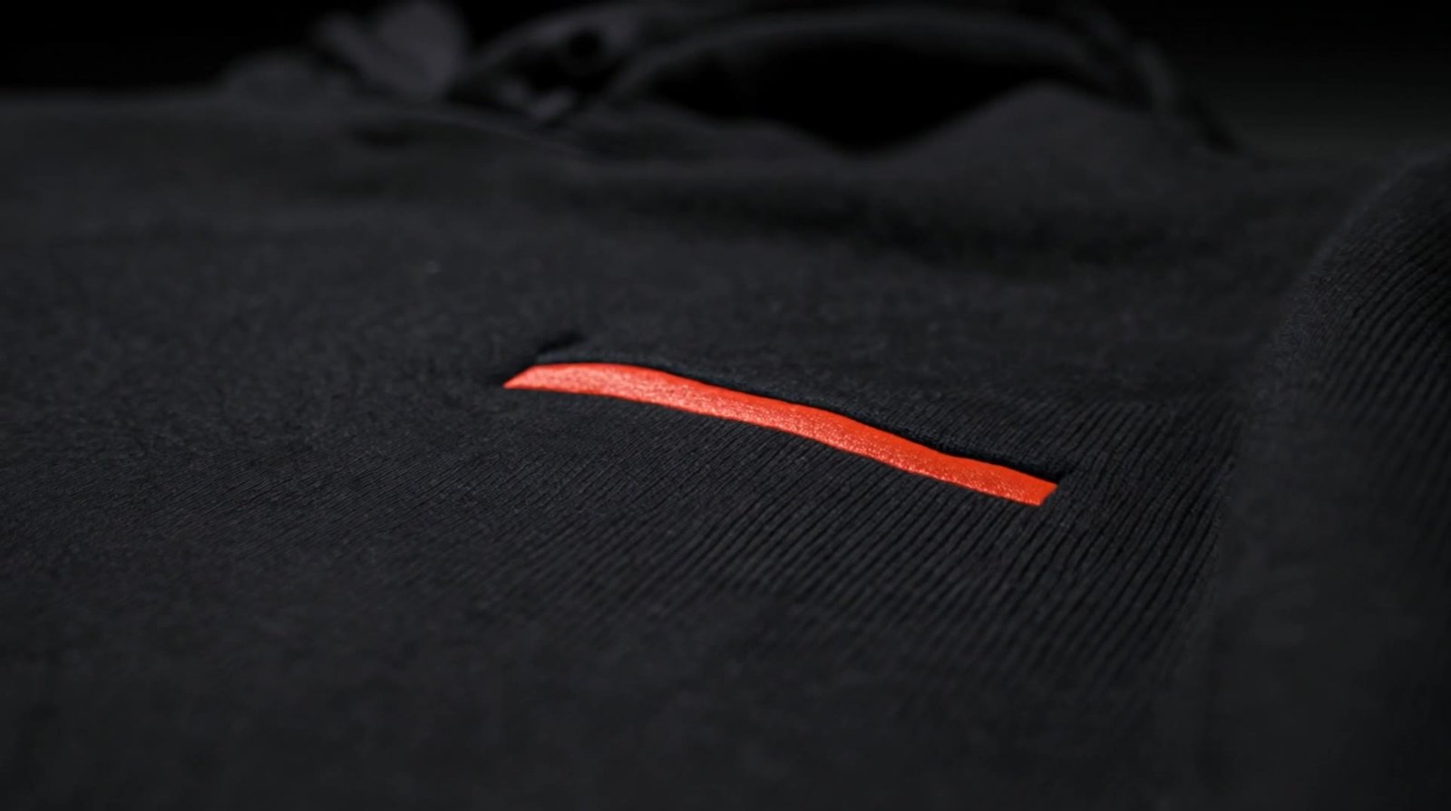 Macro of the red embroidered bar on black fleece